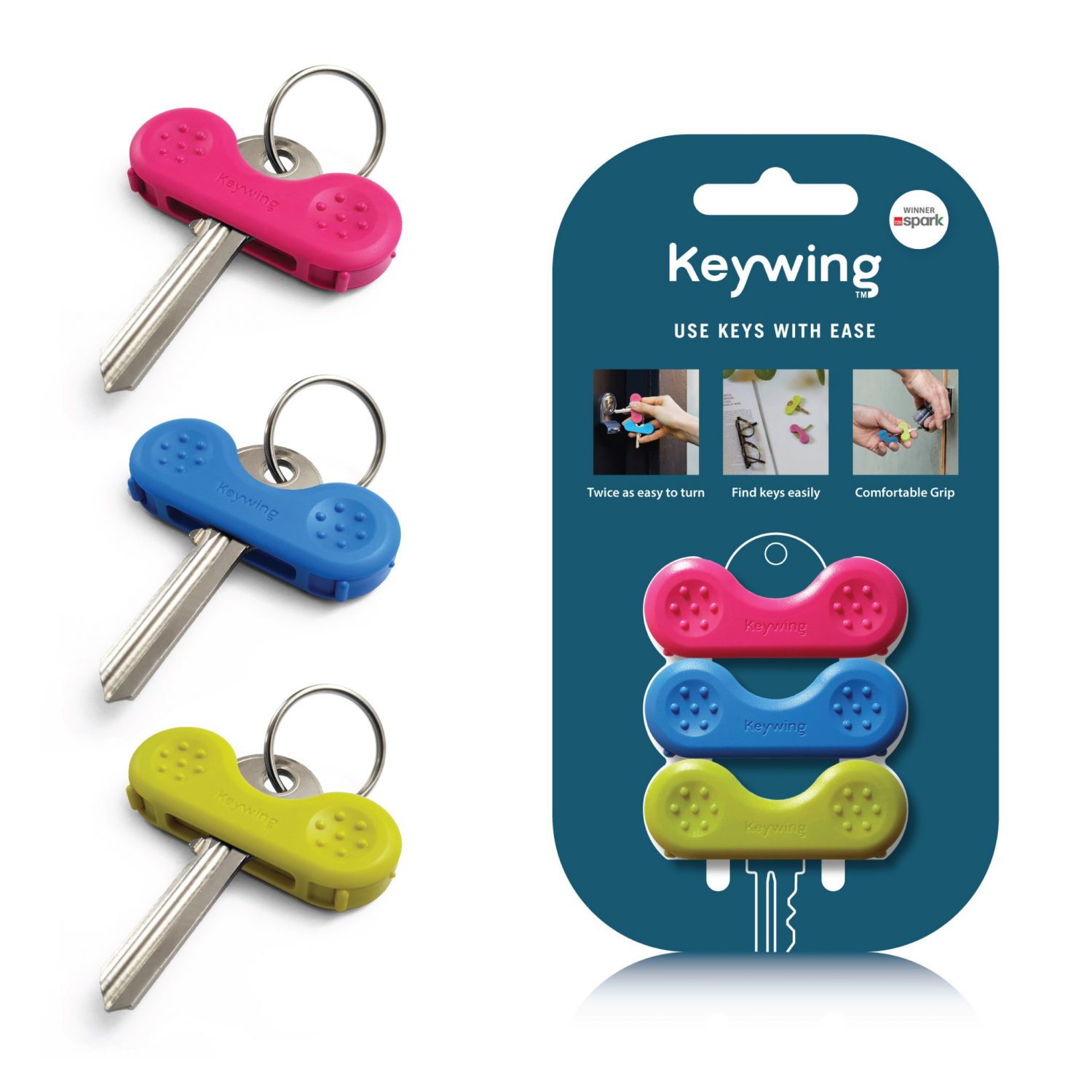 Three Keywing tools in pink, blue and yellow on keys