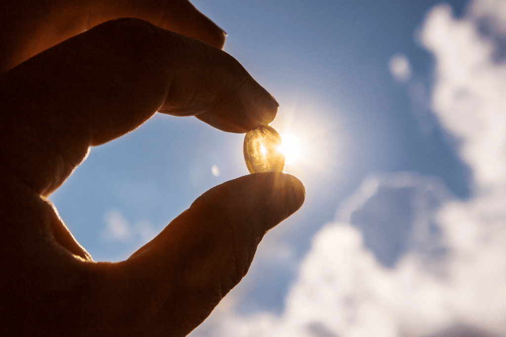 Sun shining through a pill with sky in the background