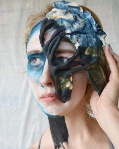A young woman wearing a mask